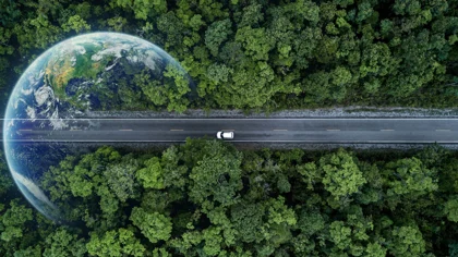 Picture of tops of trees with a car on a road in the middle, with a translucent image of the earth